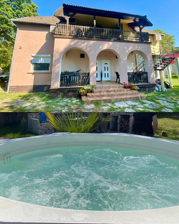 a house with a pool of water in front of it at Tieffapartmanház Zamardi in Zamárdi