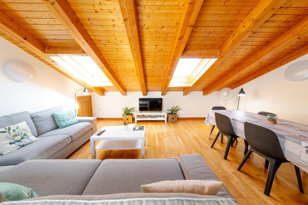 a living room with a couch and a table at RENOVADO - Ático Plaza Herradores, céntrico y con Wifi in Soria