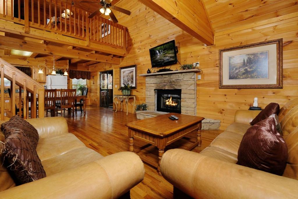 a living room with a couch and a fireplace at Mountain Serenity in Gatlinburg