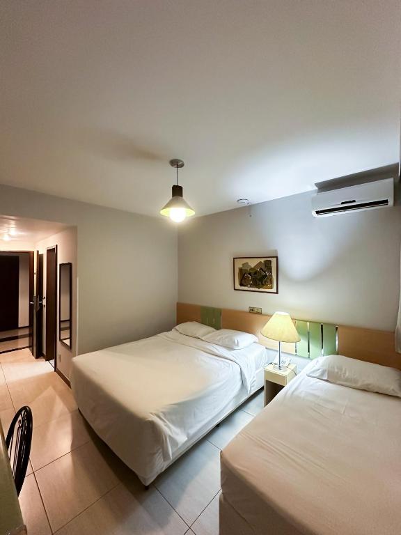 Postel nebo postele na pokoji v ubytování Sumatra Hotel e Centro de Convenções