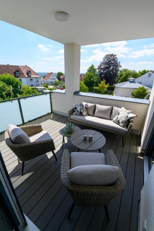 a patio with a couch and chairs on a deck at Ferienwohnung in Warburg in Warburg