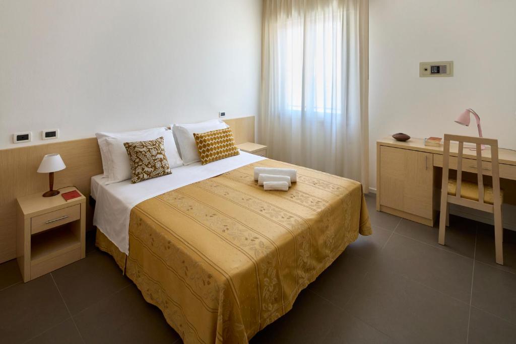 Postel nebo postele na pokoji v ubytování Hotel Dolores