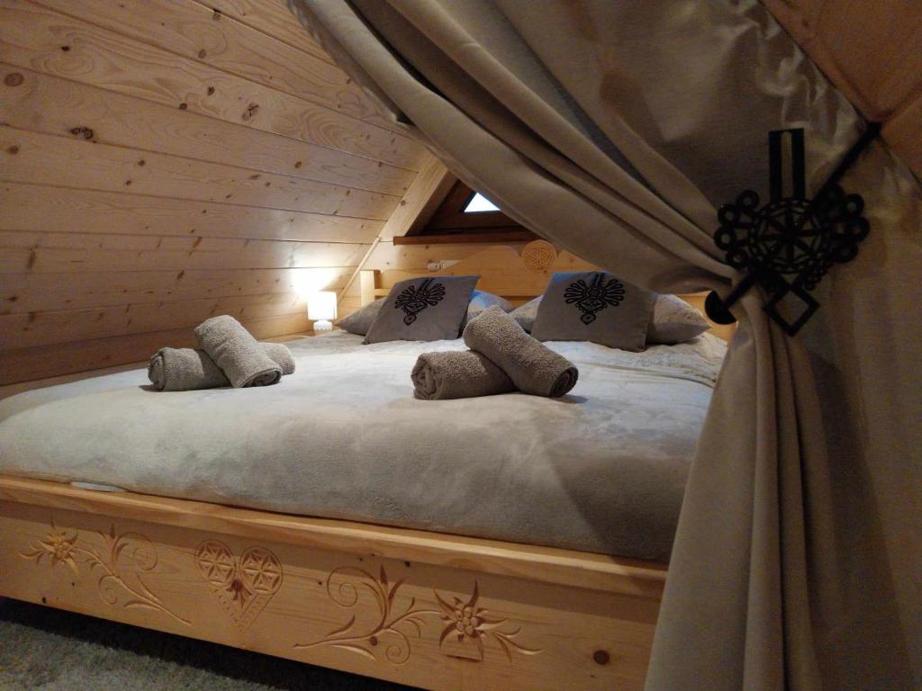 a bedroom with a bed with a canopy at Domki Na Brzyzku - Domek w górach z balią z jacuzzi in Zakopane