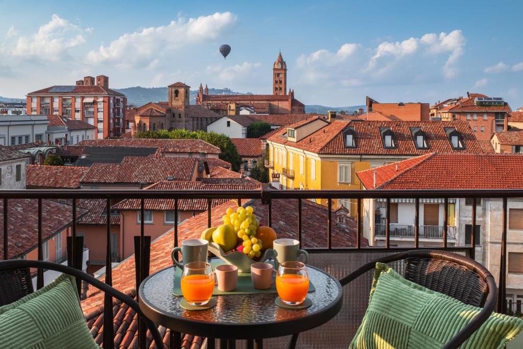 a table with a bowl of fruit on a balcony at Panoramic Alba View, 2 Bedrooms with King Beds, Free Parking - La Dolce Vista in Alba