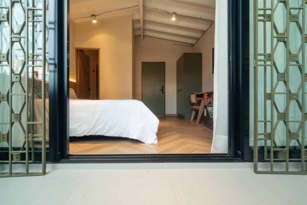 Postel nebo postele na pokoji v ubytování Hotel Boutique Roomzz Laureles