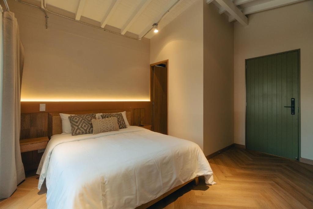 Postel nebo postele na pokoji v ubytování Hotel Boutique Roomzz Laureles