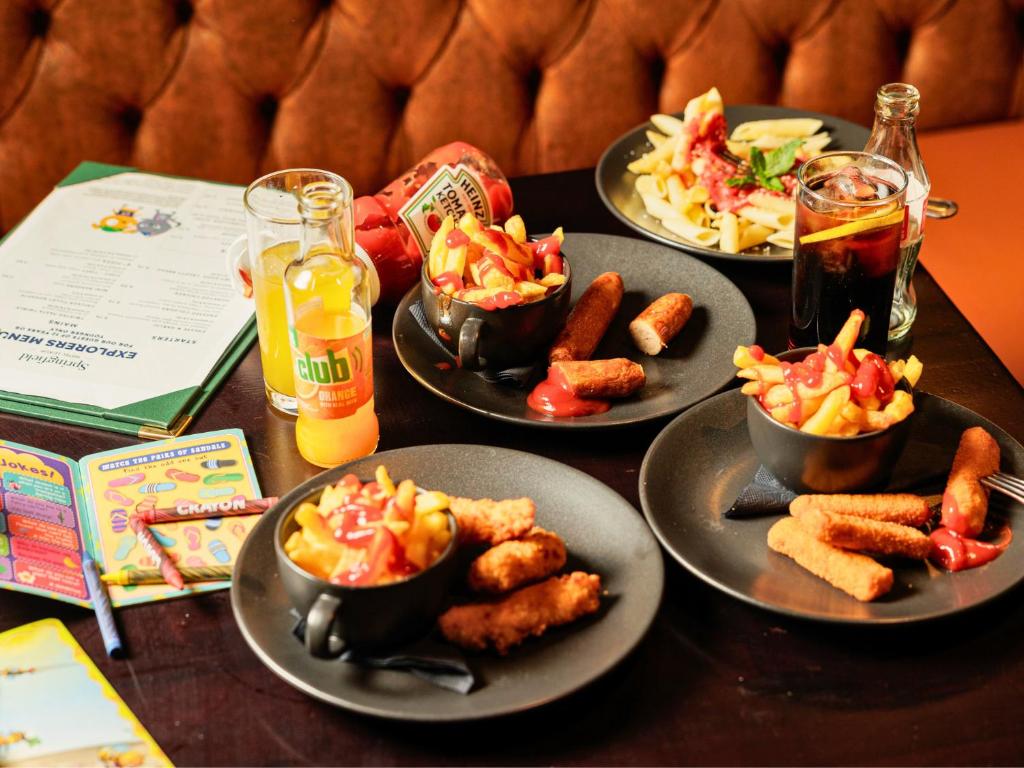 a table with four plates of food and drinks at Springfield Hotel in Leixlip