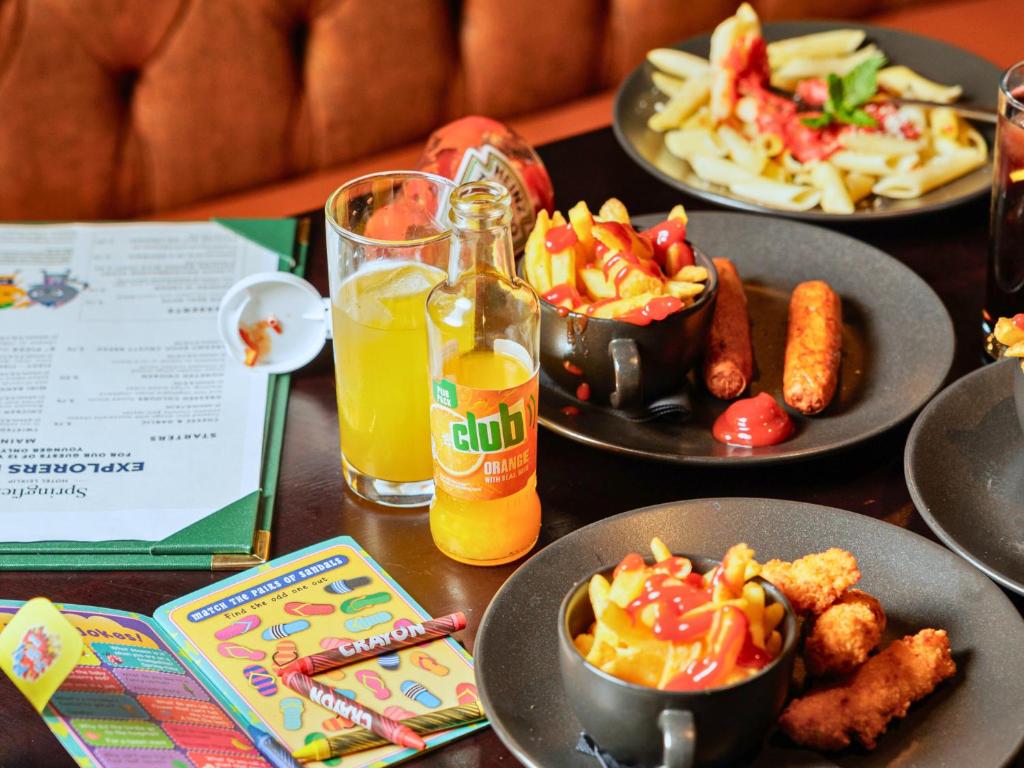 a table with plates of food and a bottle of beer at Springfield Hotel in Leixlip