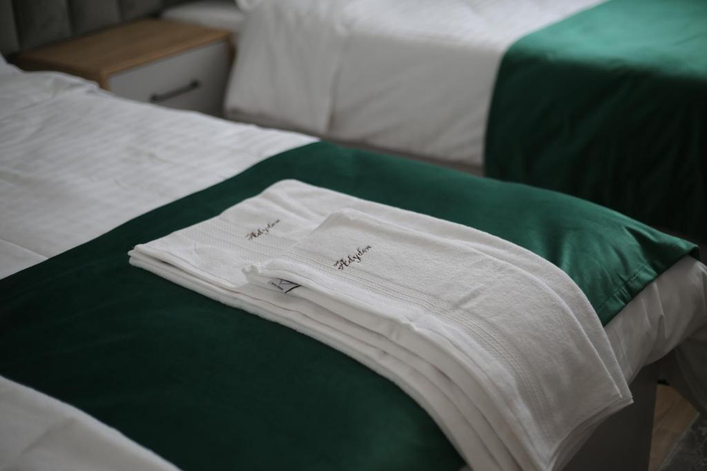 a white shirt sitting on top of a bed at Camere de inchiriat Adyden in Arbore