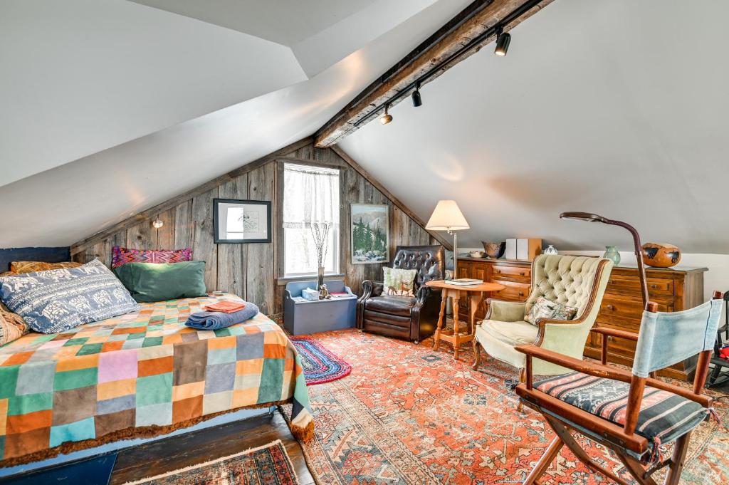 a bedroom with a bed and a desk and chairs at Cozy Catskills Vacation Rental with Deck! in Fleischmanns