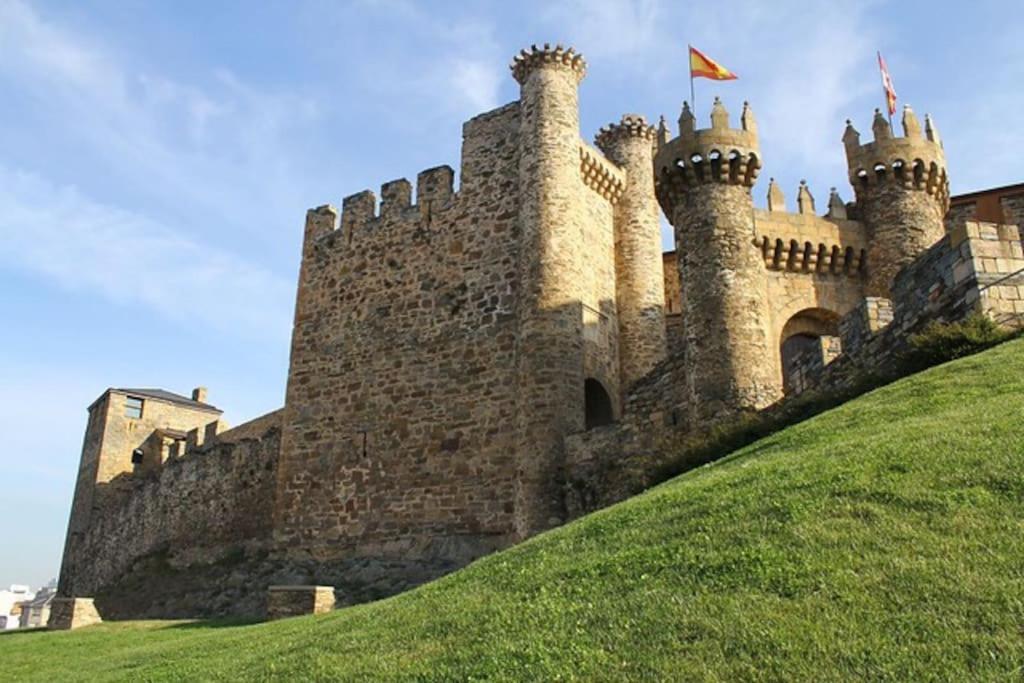 a castle on top of a grassy hill at Castillo Buenavista in Ponferrada