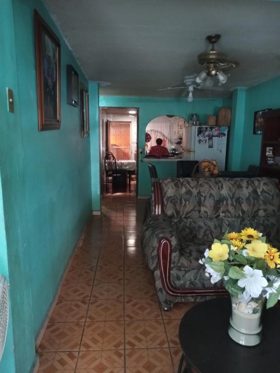 a living room with a couch and a table at hacienda los tulipanes in Monterrey