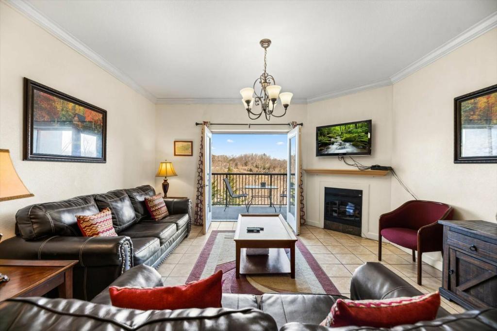 a living room with a couch and a fireplace at Vacation Destination in Pigeon Forge