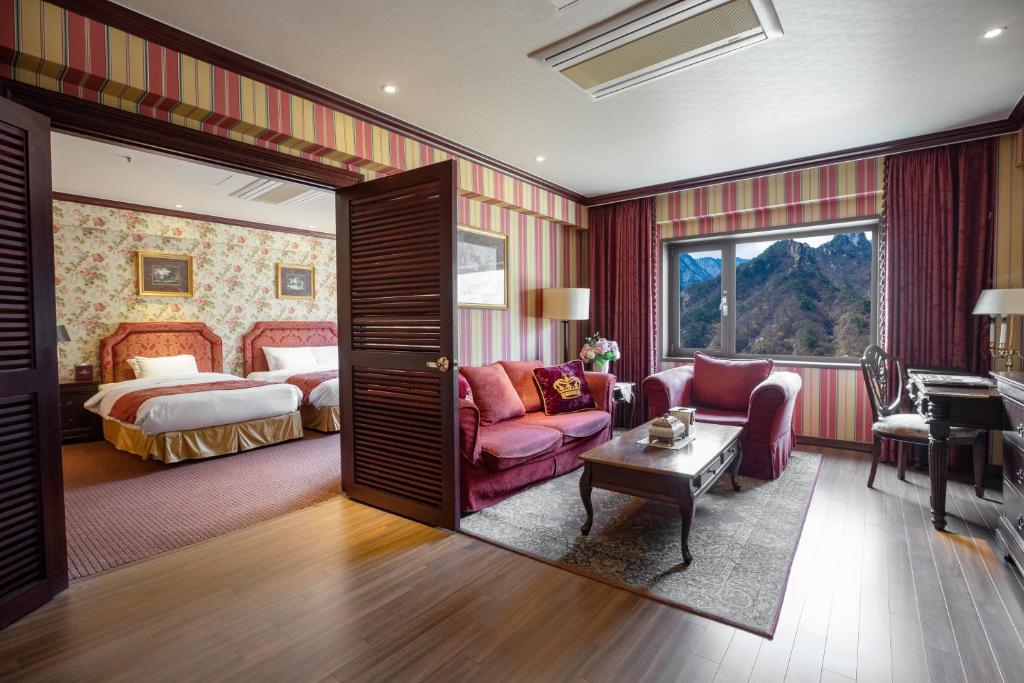a hotel room with a bed and a living room at KensingtonHotel Seorak in Sokcho