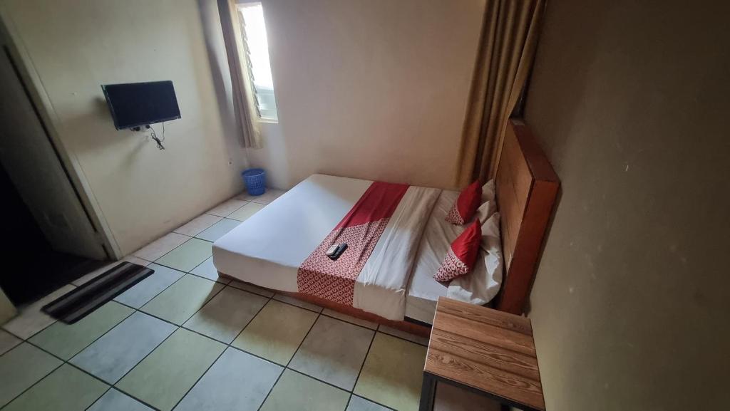 Postel nebo postele na pokoji v ubytování Wisma Alamanda