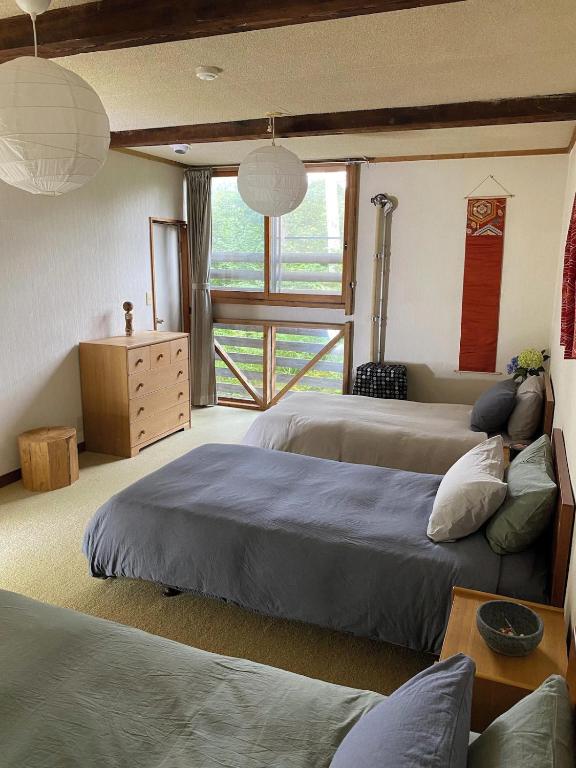 Postel nebo postele na pokoji v ubytování Yamadasan Ski Lodge - Madarao