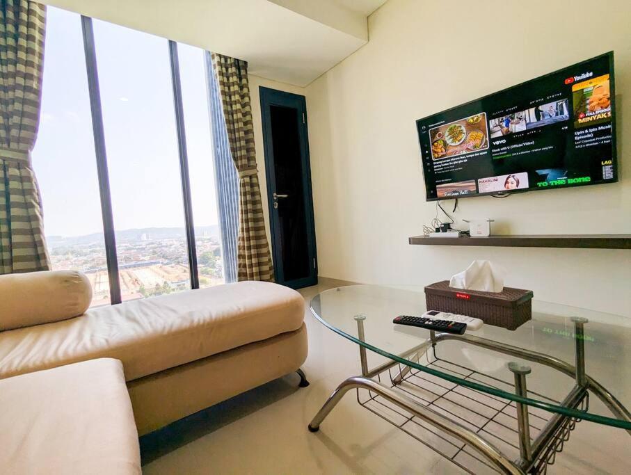 a living room with a couch and a glass table at Lovina 12- 20 at Pollux Meisterstadt in Batam Center