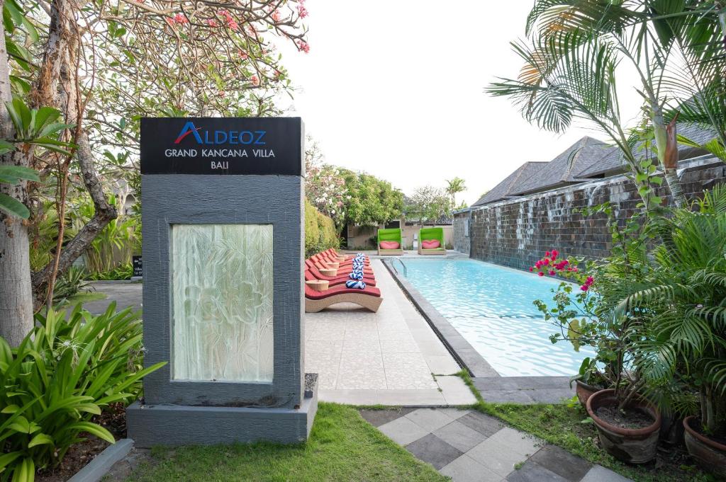 a sign for a villa with a swimming pool at Aldeoz Grand Kancana Villas Resort Bali in Kerobokan