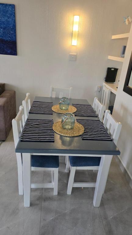 a black table with hats on top of it at Chakas Rock Chalet 39 in Ballito