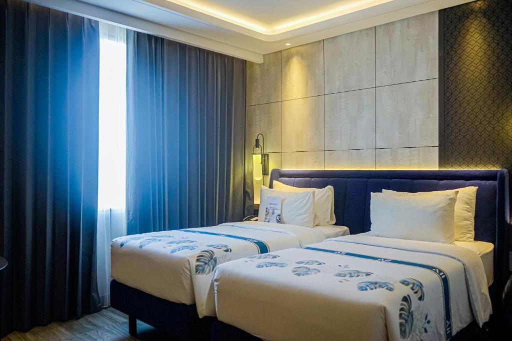 Postel nebo postele na pokoji v ubytování Mercure Tangerang Centre