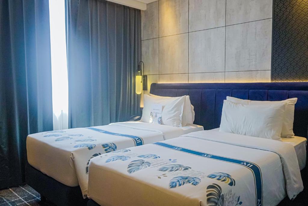Postel nebo postele na pokoji v ubytování Mercure Tangerang Centre