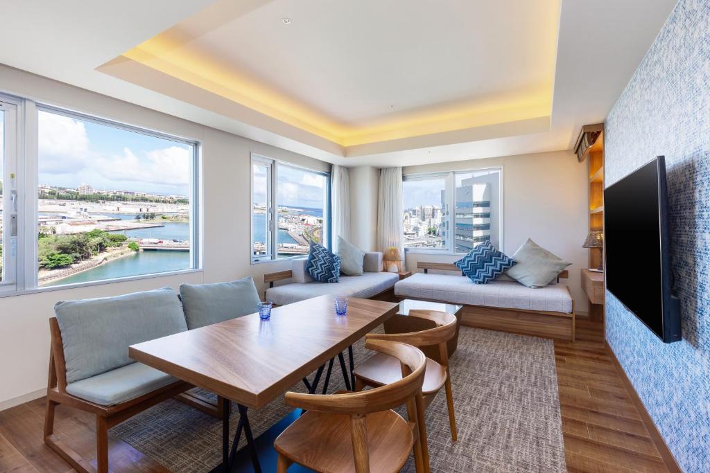 a living room with a table and a couch at Tokyu Stay Okinawa Naha in Naha