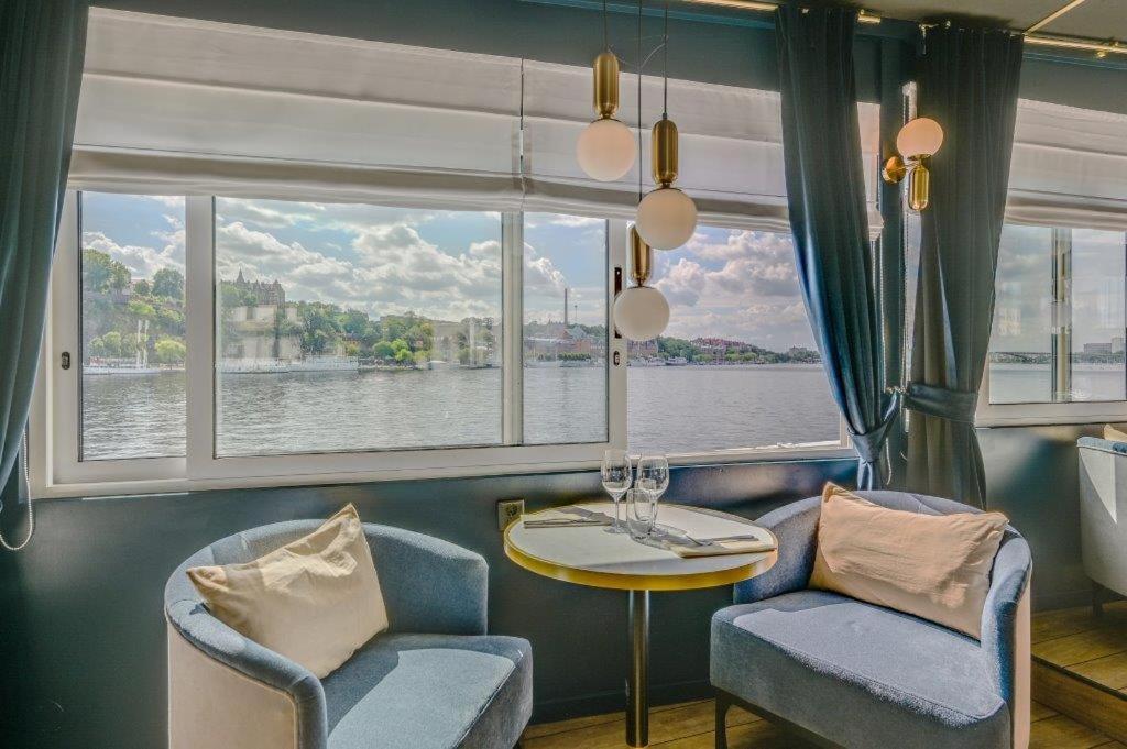 a room with a table and chairs and a window at Mälardrottningen Yacht Hotel in Stockholm