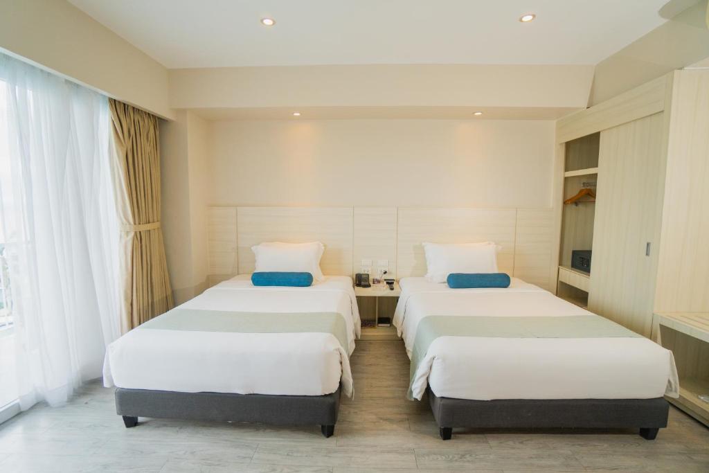 Postel nebo postele na pokoji v ubytování Solea Mactan Resort