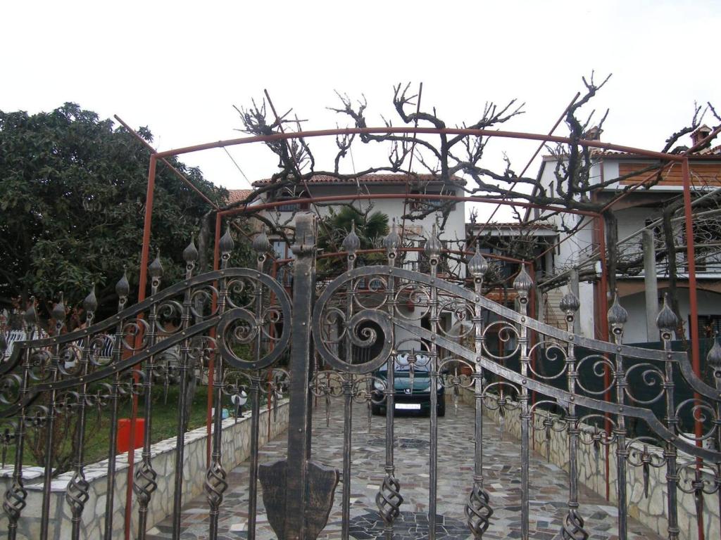 a car parked behind a wrought iron fence at Apartment Kuftic - Relax Zone - Quiet Street in Rovinj