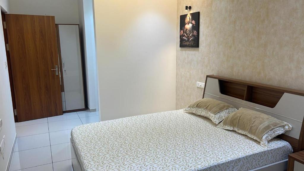a bedroom with a bed and a mirror on the wall at PENT HOUSE, Willows Apartments, Neermarga, Mangalore in Mangalore