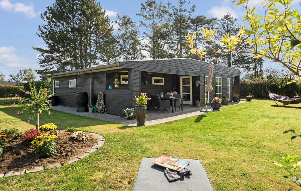 a tiny house in a yard with a garden at Cozy Home In Odder With Wifi in Odder