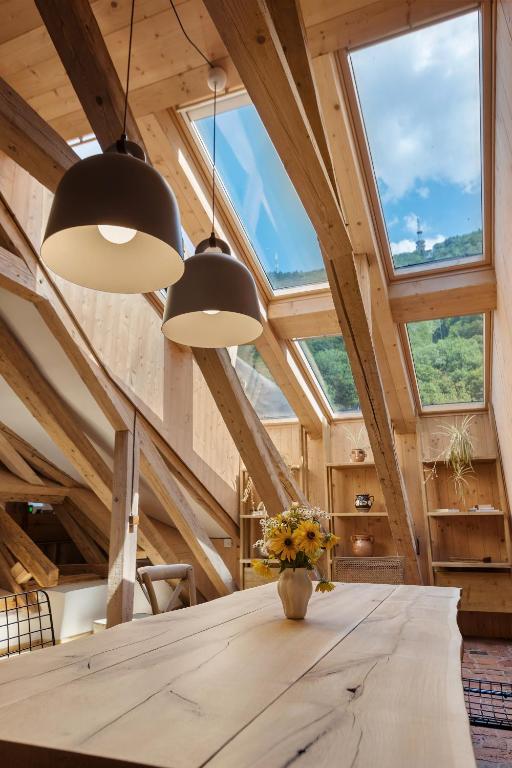 a dining room with a table and two lights at House 66 in Braşov