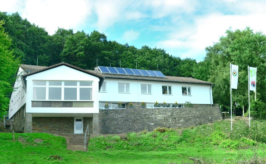 a house with solar panels on the roof at Schullandheim Kronenburg GmbH in Kronenburg