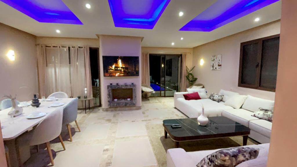 a living room with blue lights on the ceiling at Private Villa BSF - Pool & Spa - Palm Golf in Marrakesh
