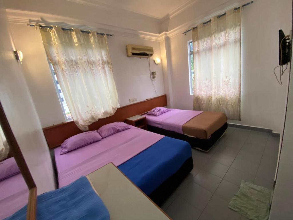 Postel nebo postele na pokoji v ubytování Dung Fang Hotel