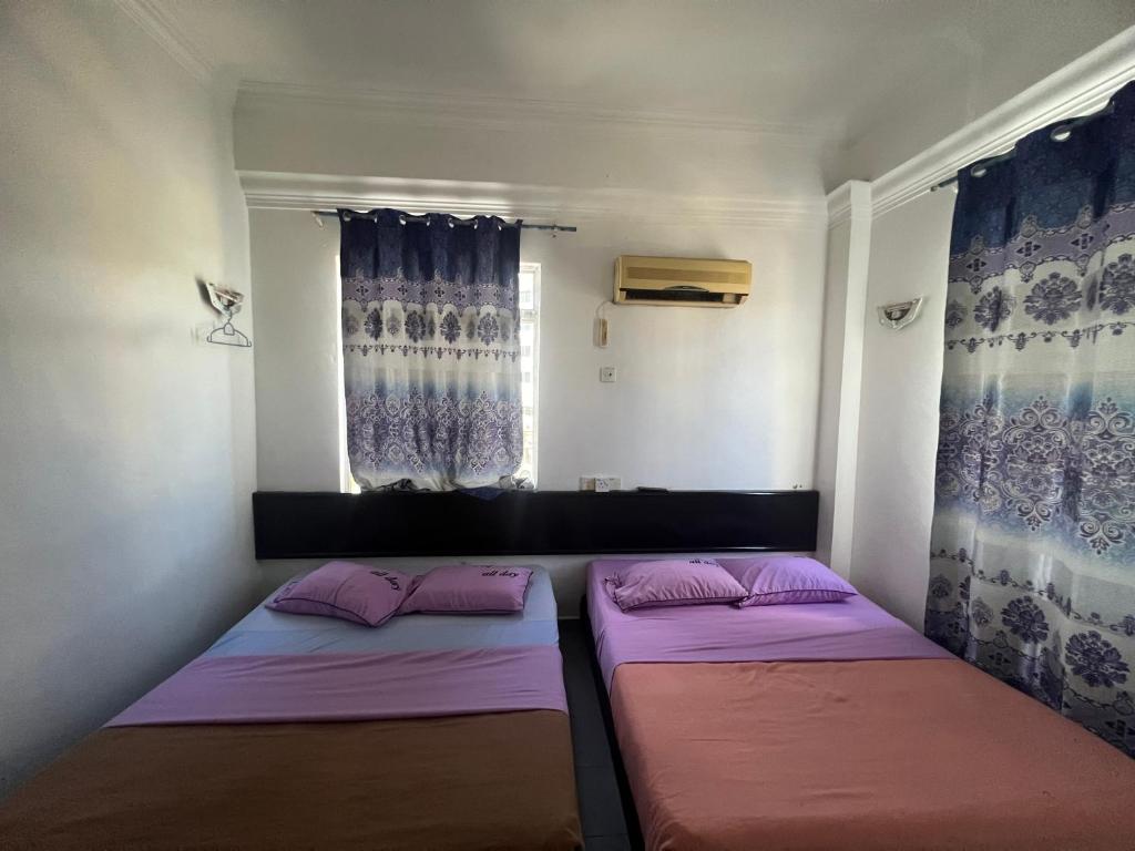 Postel nebo postele na pokoji v ubytování Dung Fang Hotel