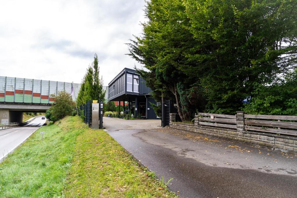 a black house on the side of a road at KMS Homes - air conditioning - near Legoland Günzburg in Bubesheim