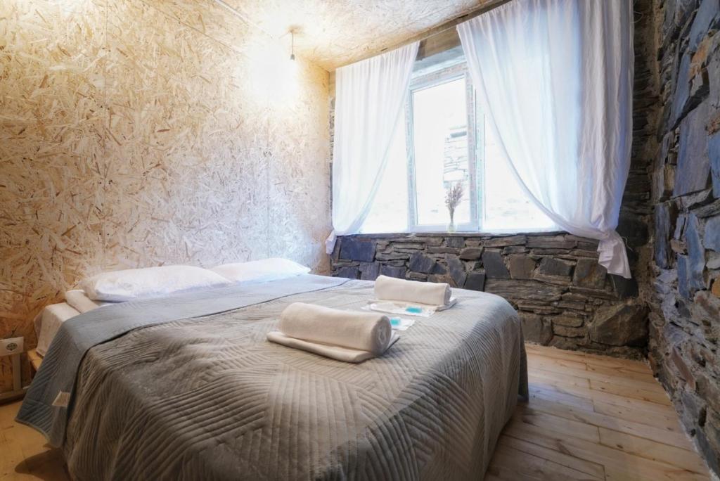 Postel nebo postele na pokoji v ubytování Agra Ushguli