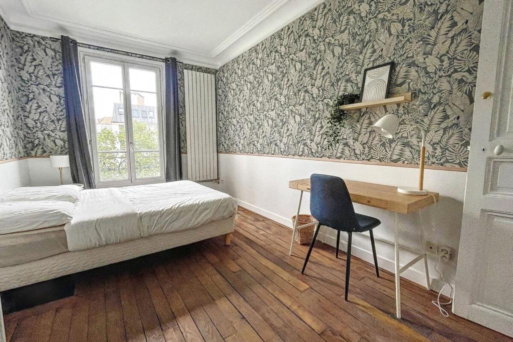 a bedroom with a bed and a desk and a window at Flexliving - room - Daumesnil in Paris