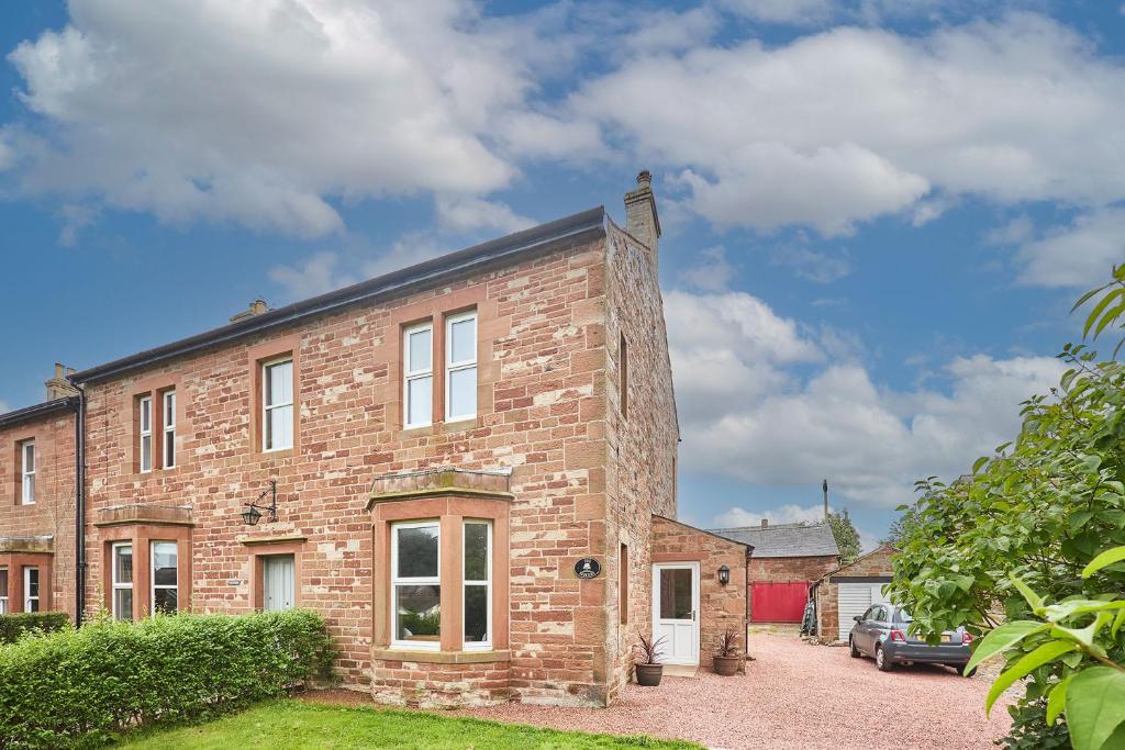 a brick house with a car parked in front of it at Host & Stay - The Beeches in Hayton