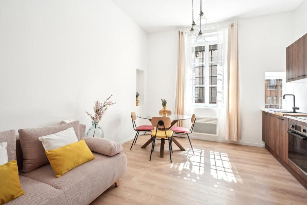 un salon avec un canapé et une table dans l'établissement Charming Berlioz Apartment for 6 People in Charpennes Villeurbanne, à Villeurbanne