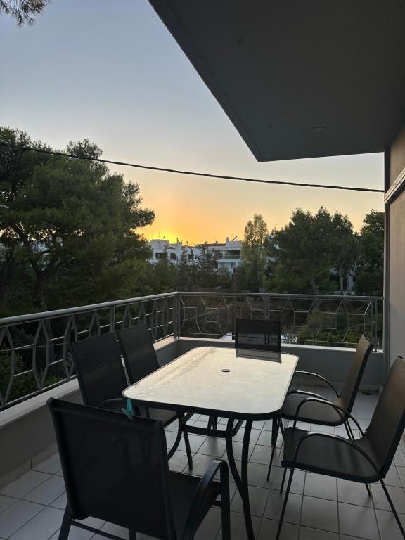 a patio with a table and chairs on a balcony at Ria's Home in Athens