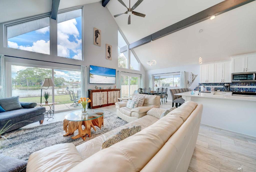 a living room with a couch and a table at Dolphin Days Lagoon Retreat in Panama City Beach