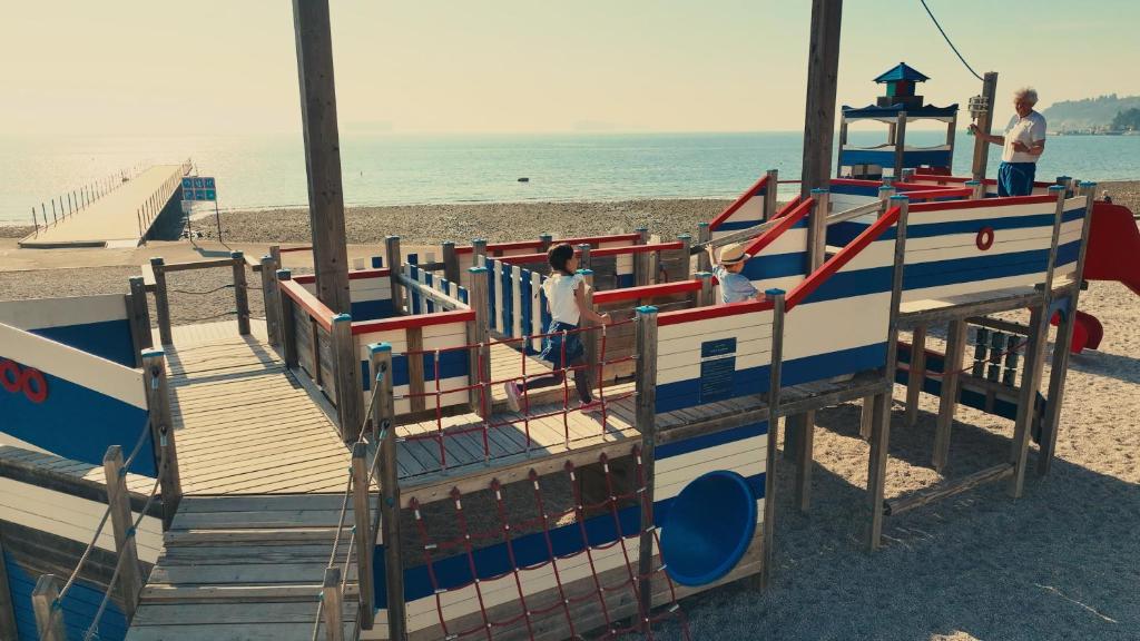a playground on the beach with people on it at Hotel Convent - Hotel & Resort Adria Ankaran in Ankaran