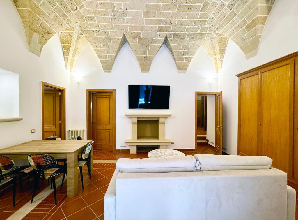 a living room with a couch and a table at Casa Ginevra, Private Garage, Vaulted Ceilings in Lecce