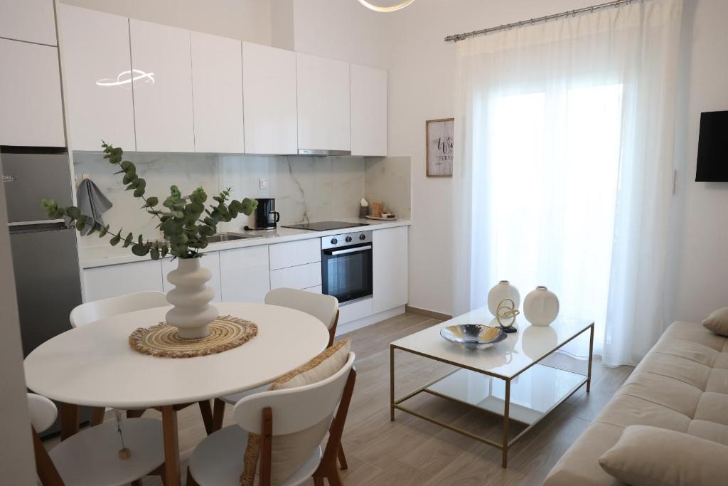 a kitchen and living room with a table and a couch at Iliana's apartment in Kardítsa