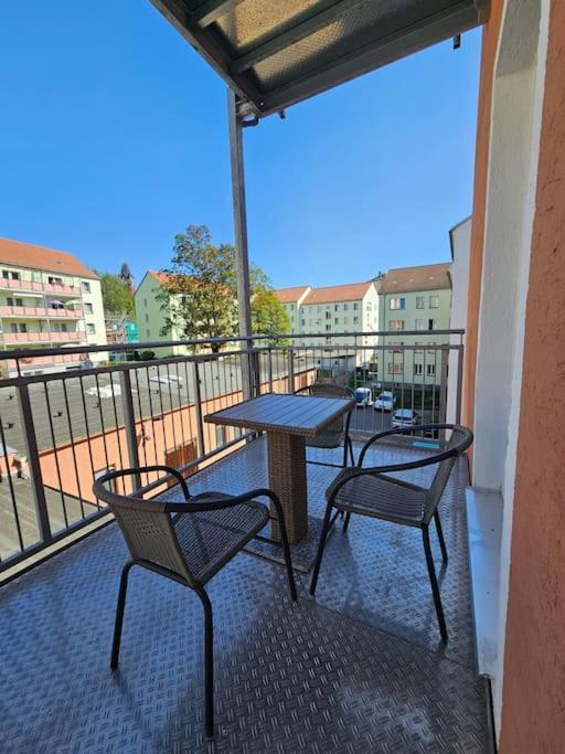 a balcony with two chairs and a table on a balcony at familienfreundlich im Zentrum Citypoint in Plauen