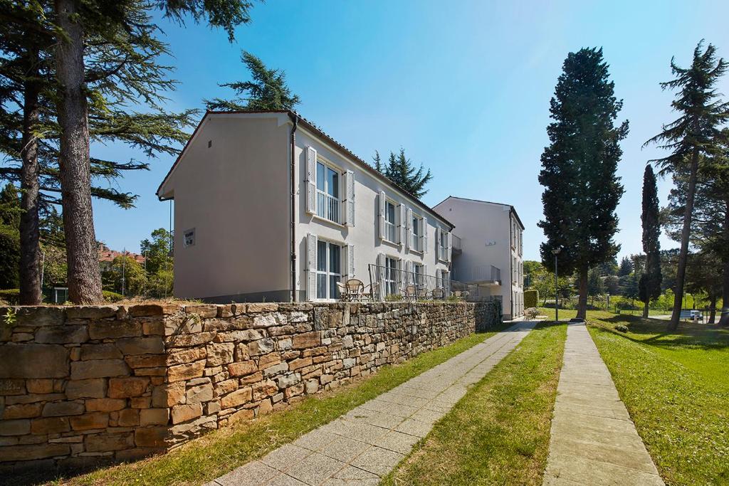 a stone wall in front of a building at Villas - Hotel & Resort Adria Ankaran in Ankaran