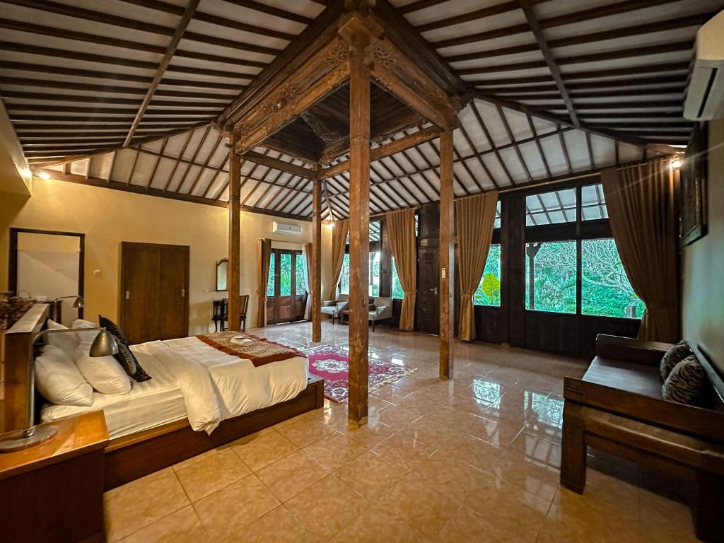 Postel nebo postele na pokoji v ubytování Kampoeng Joglo Abangan Ubud