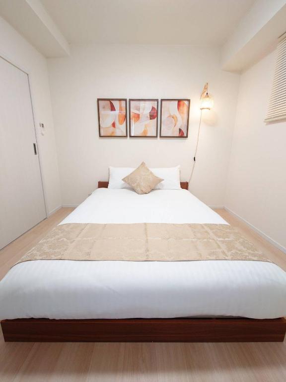 Postel nebo postele na pokoji v ubytování Neighbor's Hotel 十日市